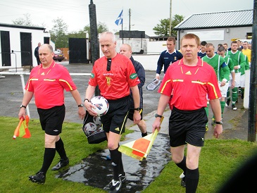 Match Officials lead out the teams with R Cousins  (nafl) Donald McGuffie (safa) & R Newell (nafl)